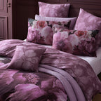Floral patterned bedding set on a bed with a dark wooden headboard.