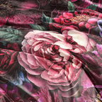 Close-up of a floral pattern with pink and red flowers on a dark background