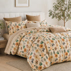 Floral bedding set on a bed in a bedroom with a plant and side table.