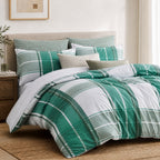 Green and white plaid bedding set on a bed in a bedroom.