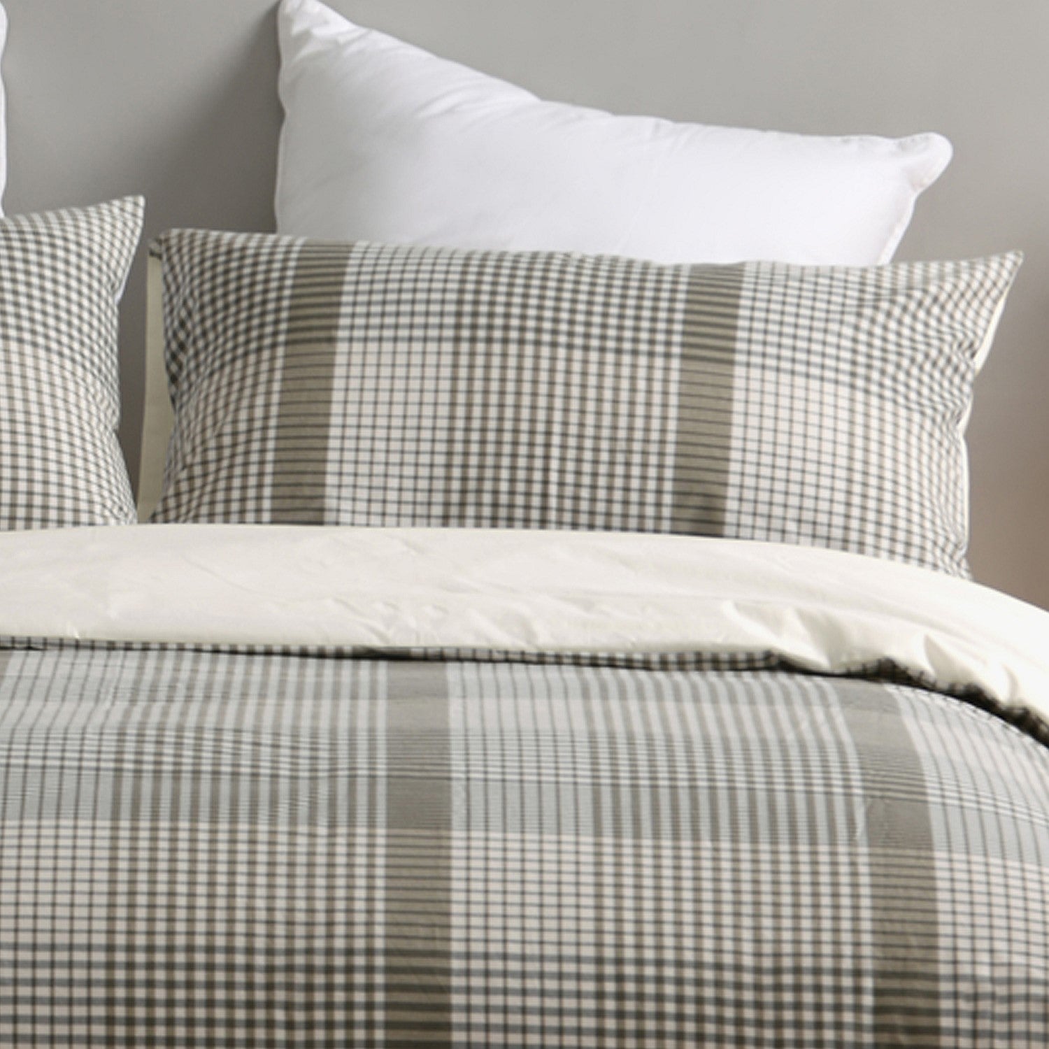 Checkered bedding set with pillows on a neutral background