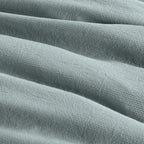 Close-up of textured light blue fabric with a subtle pattern