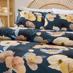 Floral patterned bedding set on a bed with a wicker headboard.