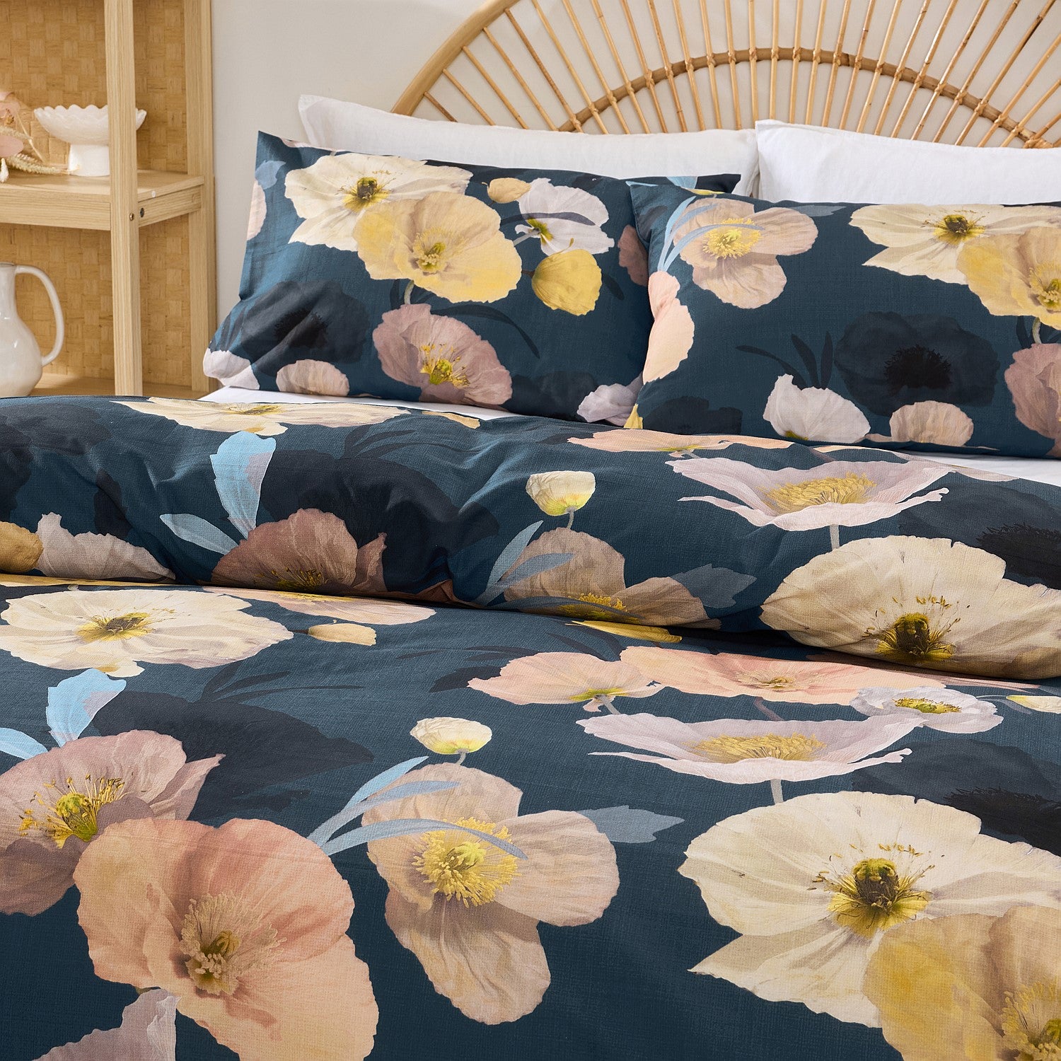 Floral patterned bedding set on a bed with a wicker headboard.