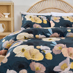 Floral bedding set on a bed with a wicker headboard