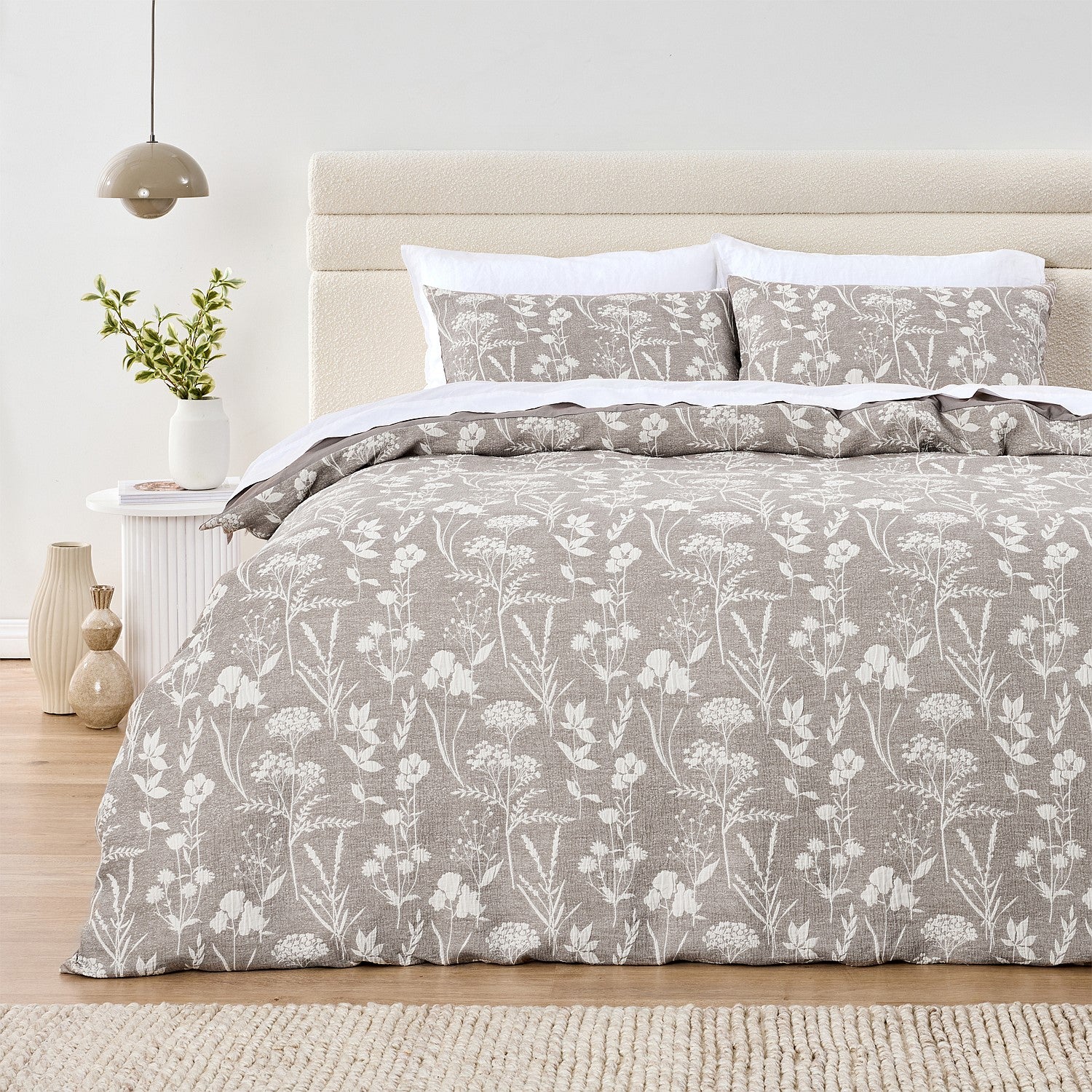 Bed with floral patterned bedding in a bedroom setting