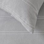 Gray textured fabric with a folded corner on a matching background