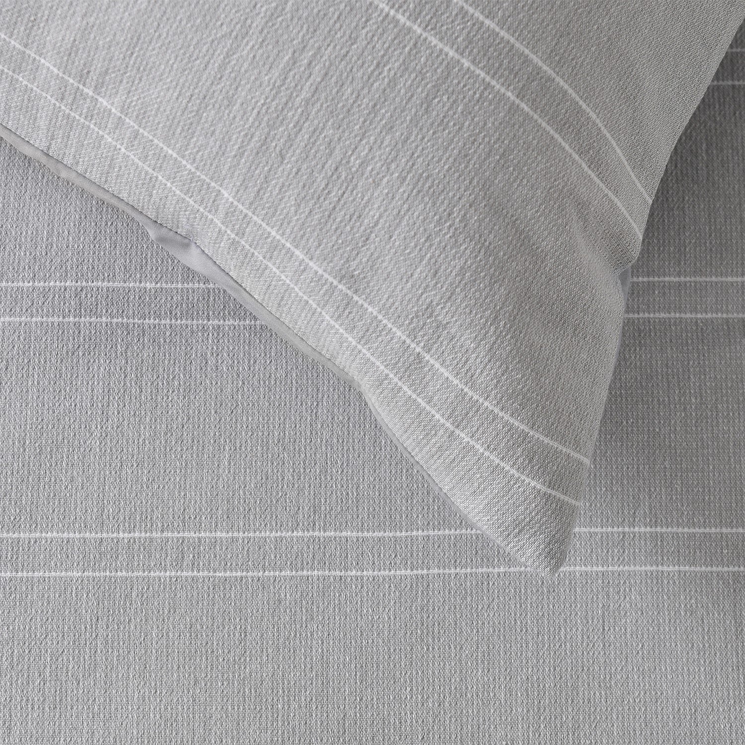 Gray textured fabric with a folded corner on a matching background