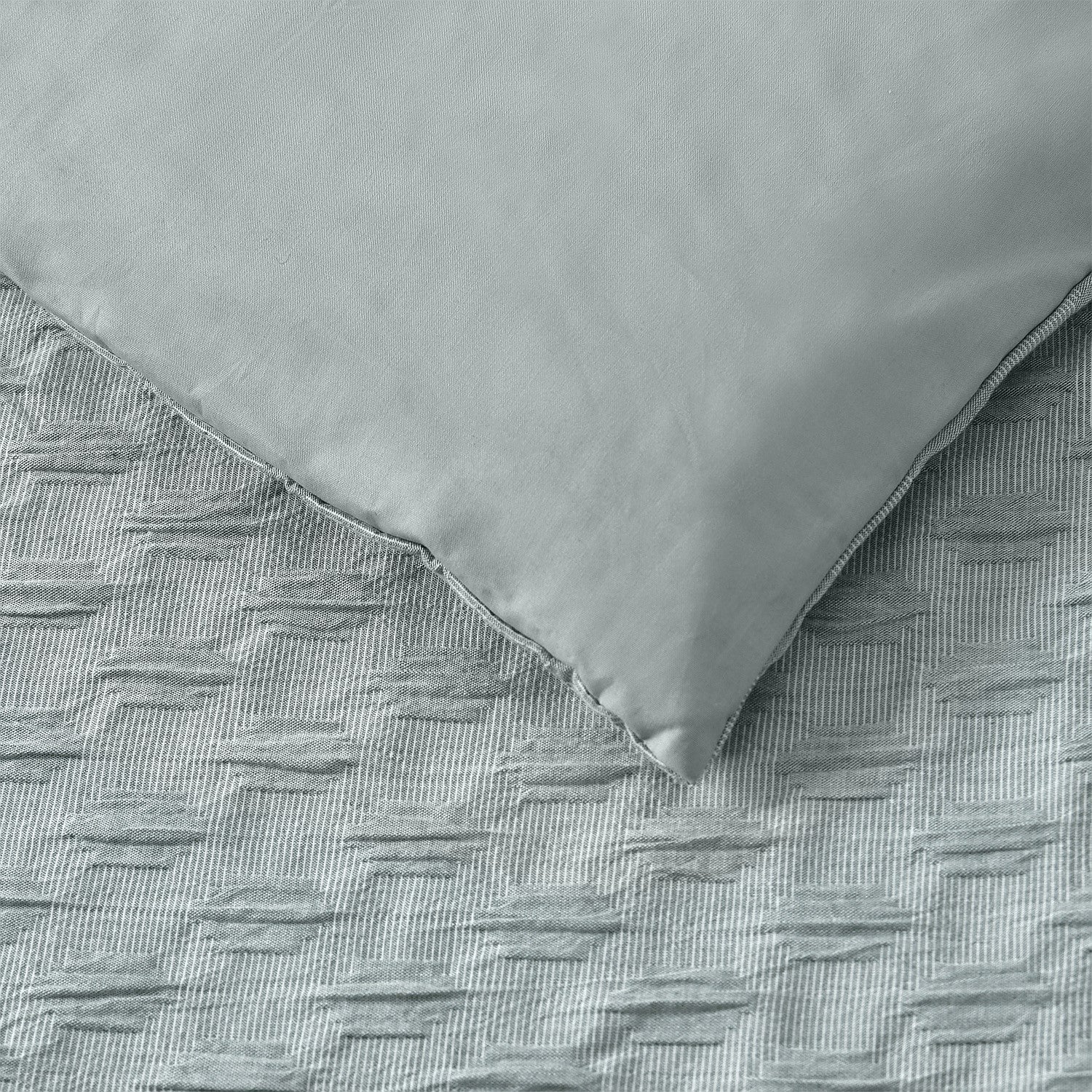 Gray textured blanket on a matching fabric surface