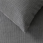 Gray textured fabric with a pillow on top