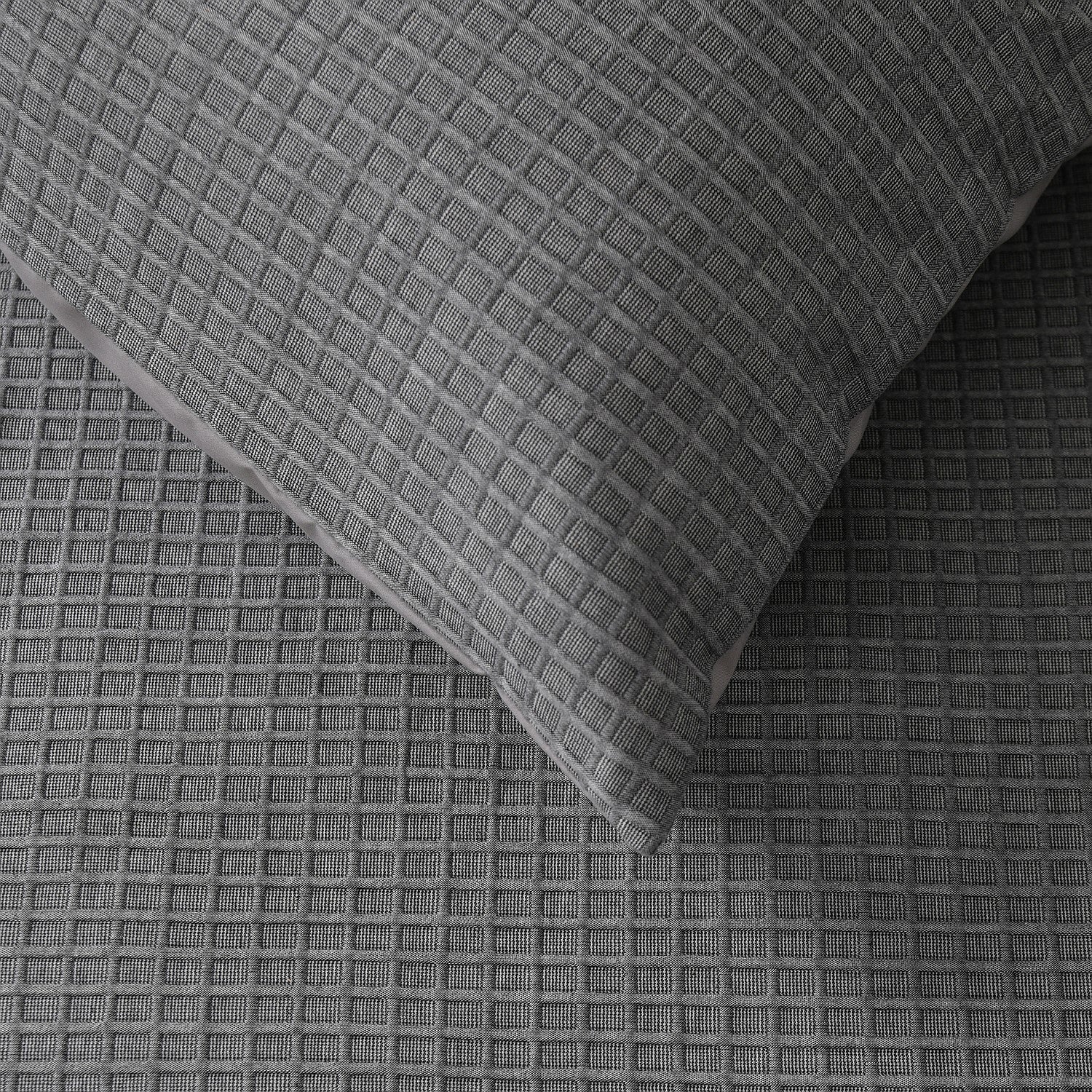 Gray textured fabric with a pillow on top