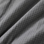 Close-up of textured gray fabric with a diamond pattern