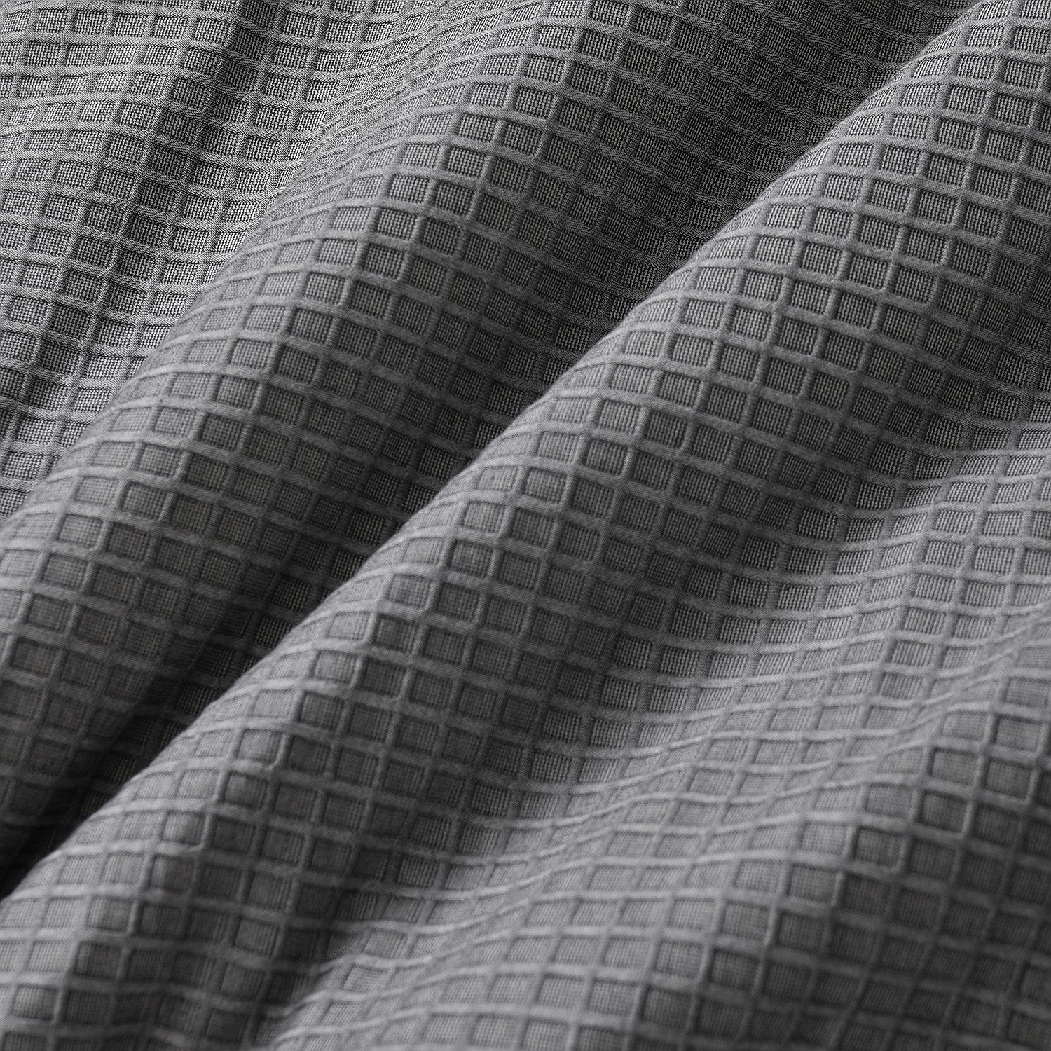 Close-up of textured gray fabric with a diamond pattern