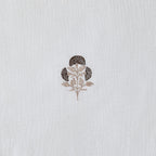 Embroidered floral design on a textured white fabric background