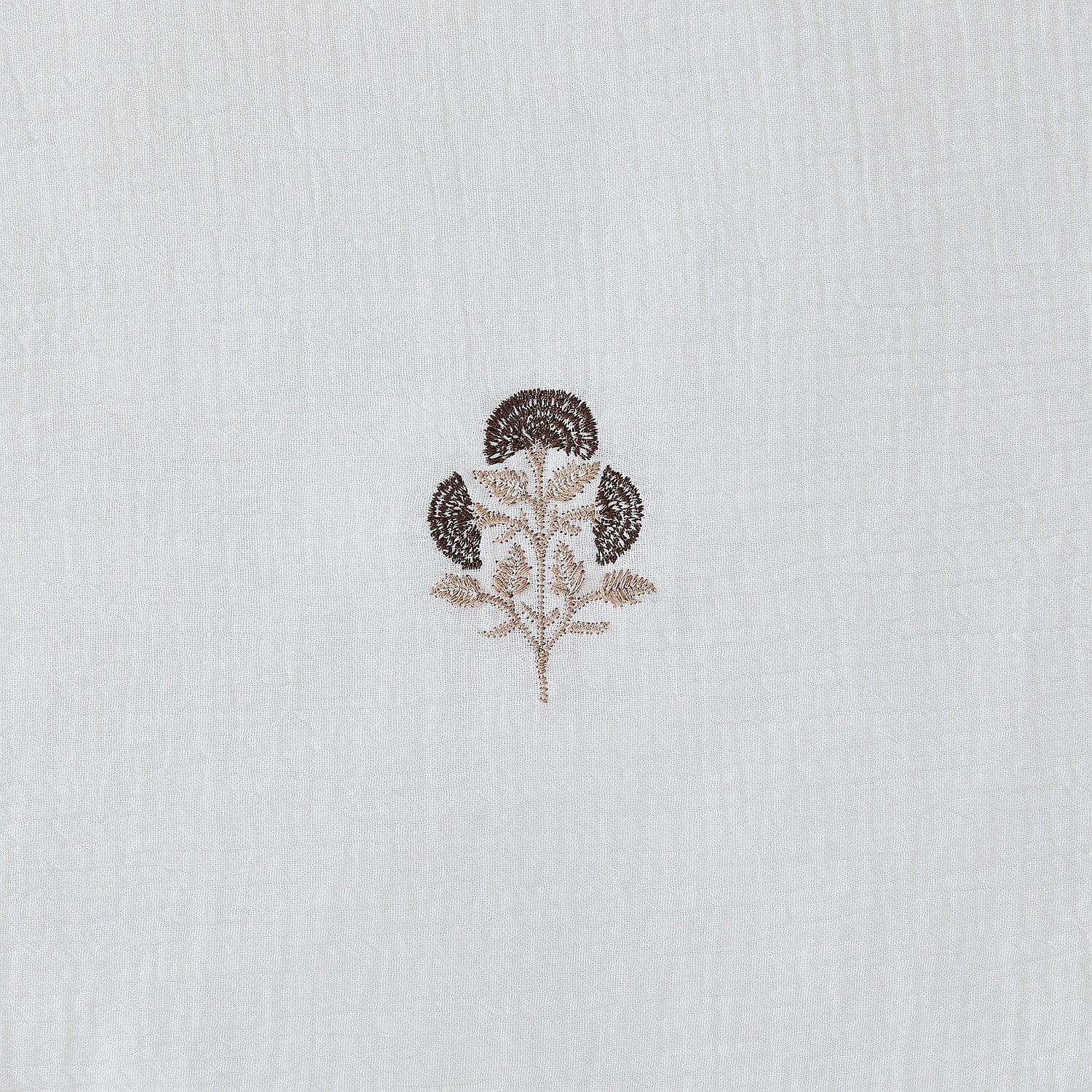 Embroidered floral design on a textured white fabric background