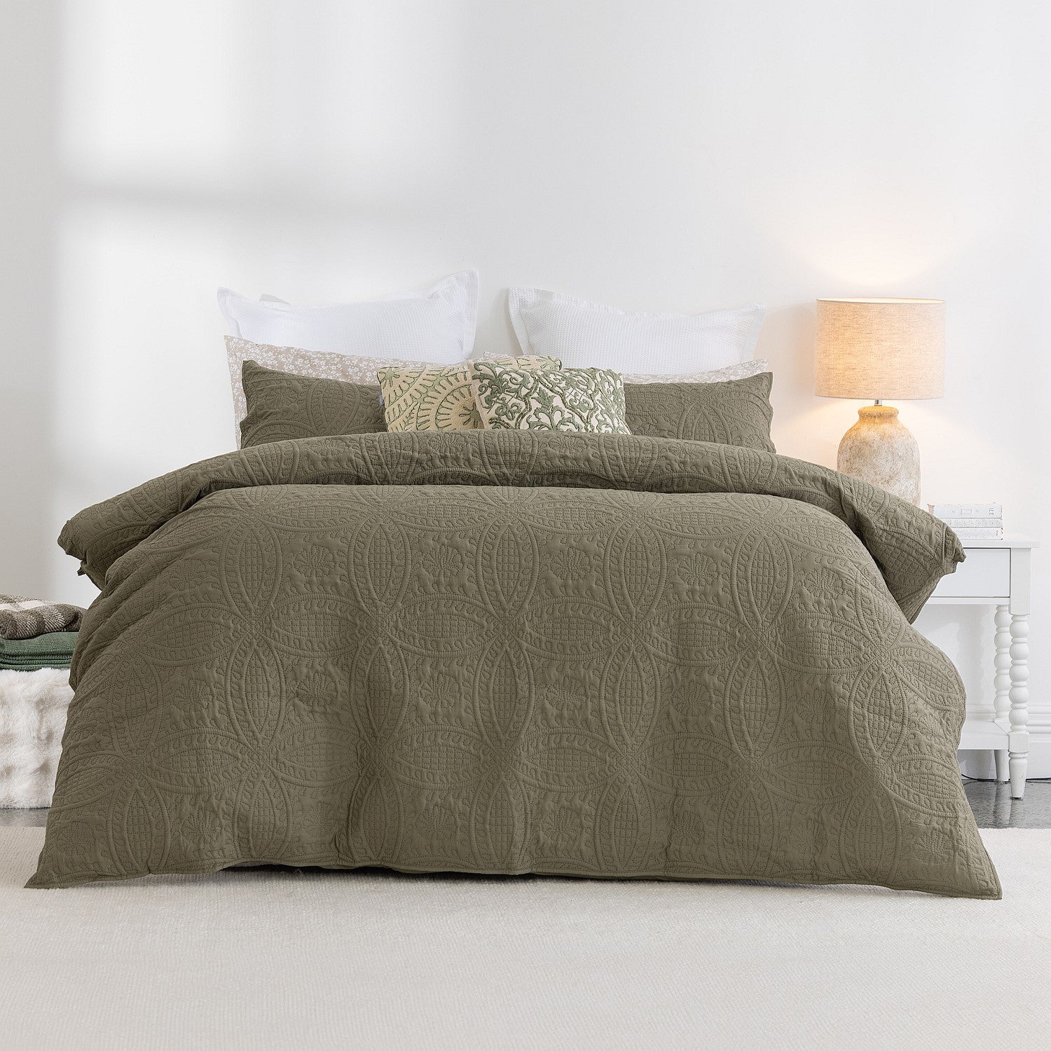 Green textured duvet cover set on a bed in a bedroom setting.
