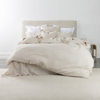 Beige bedding set on a bed in a minimalistic room