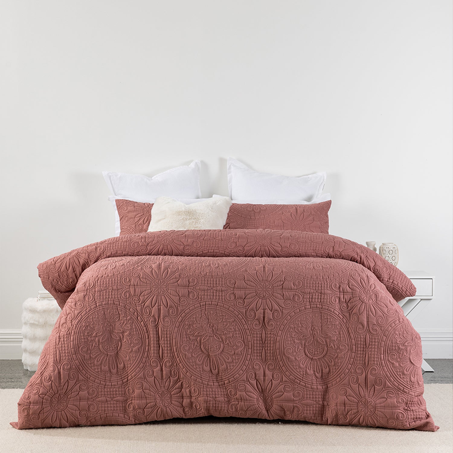 Rose embossed duvet cover set featuring an intricate medallion-inspired pattern and soft quilted texture, styled on a bed with matching pillowcases and neutral accent cushions.