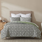 Bed styled with the Design Republique Tamara cotton duvet cover set featuring a graphite geometric floral pattern with sage green detailing.