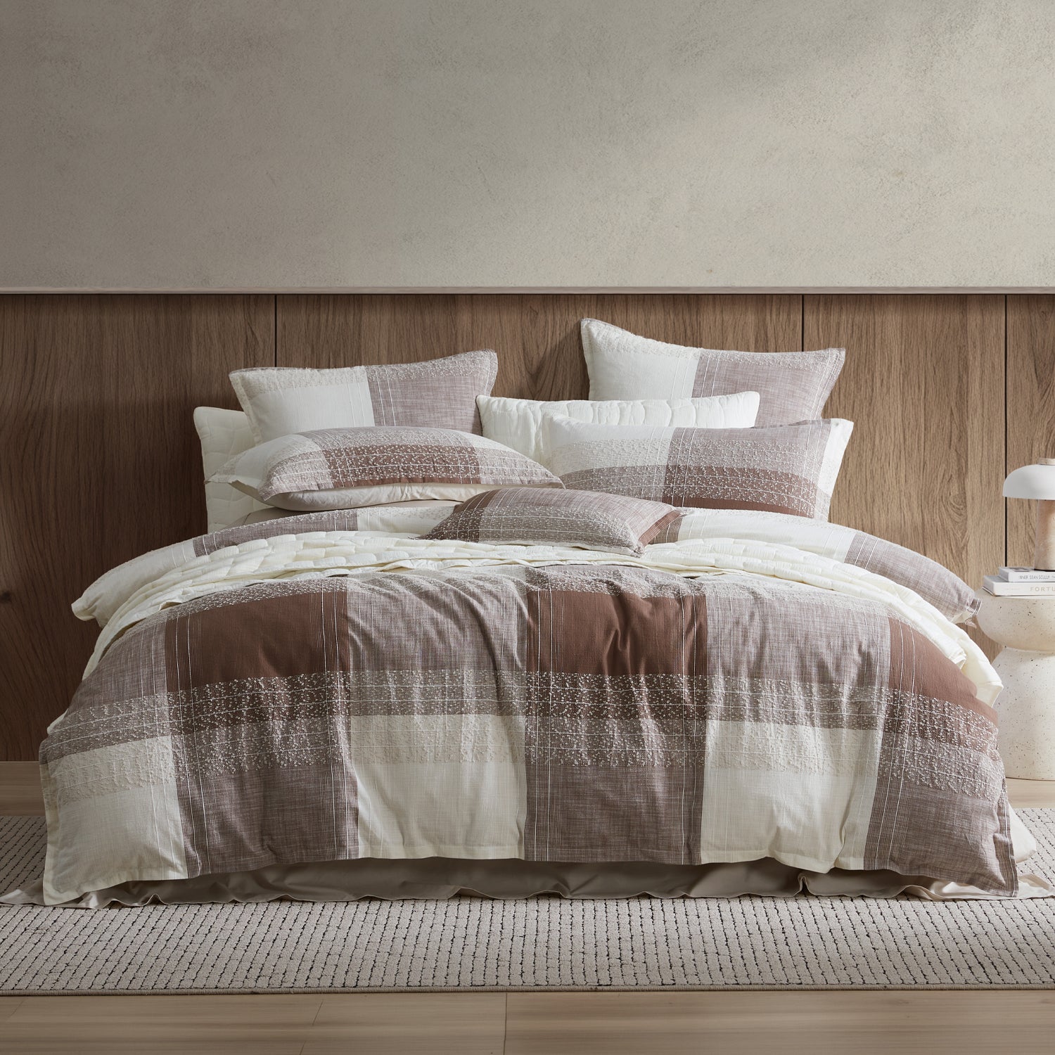 Checkered duvet cover set on a bed with a wooden headboard.