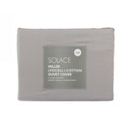Folded grey lyocell and cotton duvet cover set in retail packaging with product label displayed on a light grey background.