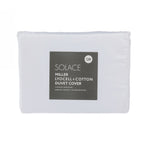 Folded white lyocell and cotton duvet cover set in retail packaging with product label displayed on a light grey background.