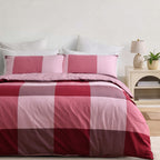 Pink, blush, berry and plum oversized check cotton duvet cover set styled on a bed with matching pillowcases.