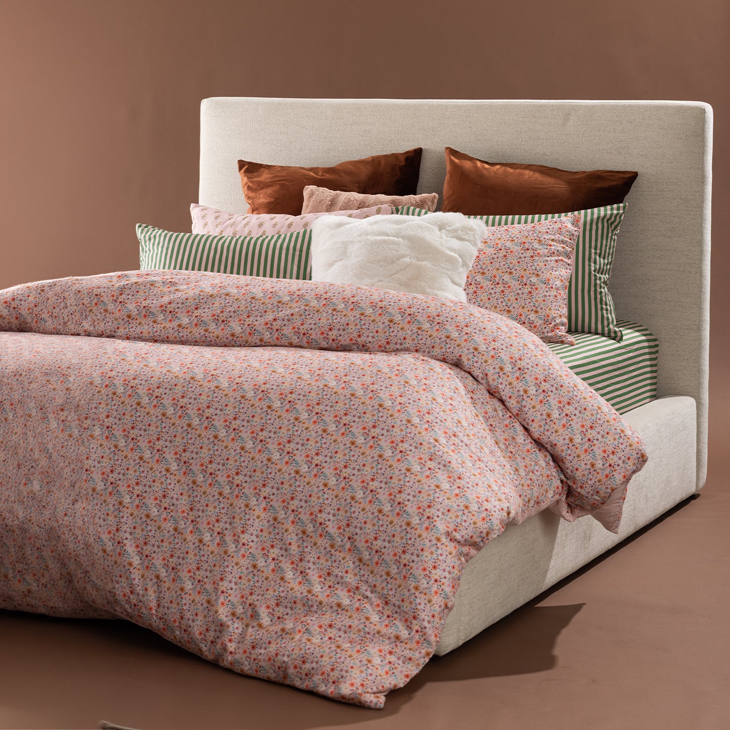 Marlo Mia Floral duvet cover set styled on a bed with coordinating striped sheets, floral pillowcases, and decorative cushions.