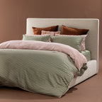 Marlo Mia Stripe duvet cover set styled on a bed with green and pink striped bedding and blush accents.