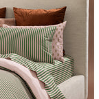 Close-up of Marlo Mia Stripe pillowcase and fitted sheet showing green and pink stripe pattern.