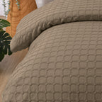 Close-up of the mocha Fieldcrest Maison cotton duvet cover and pillowcase highlighting the raised geometric textured design.