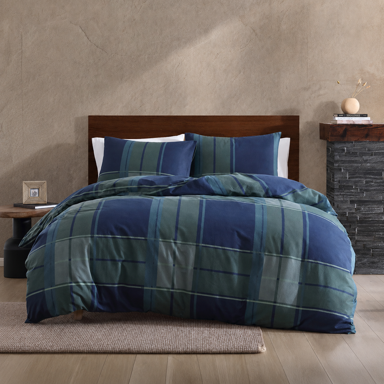 Bed with blue and green plaid comforter in a bedroom setting.