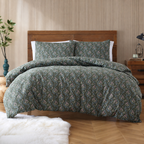 Bed with green floral bedding in a bedroom setting