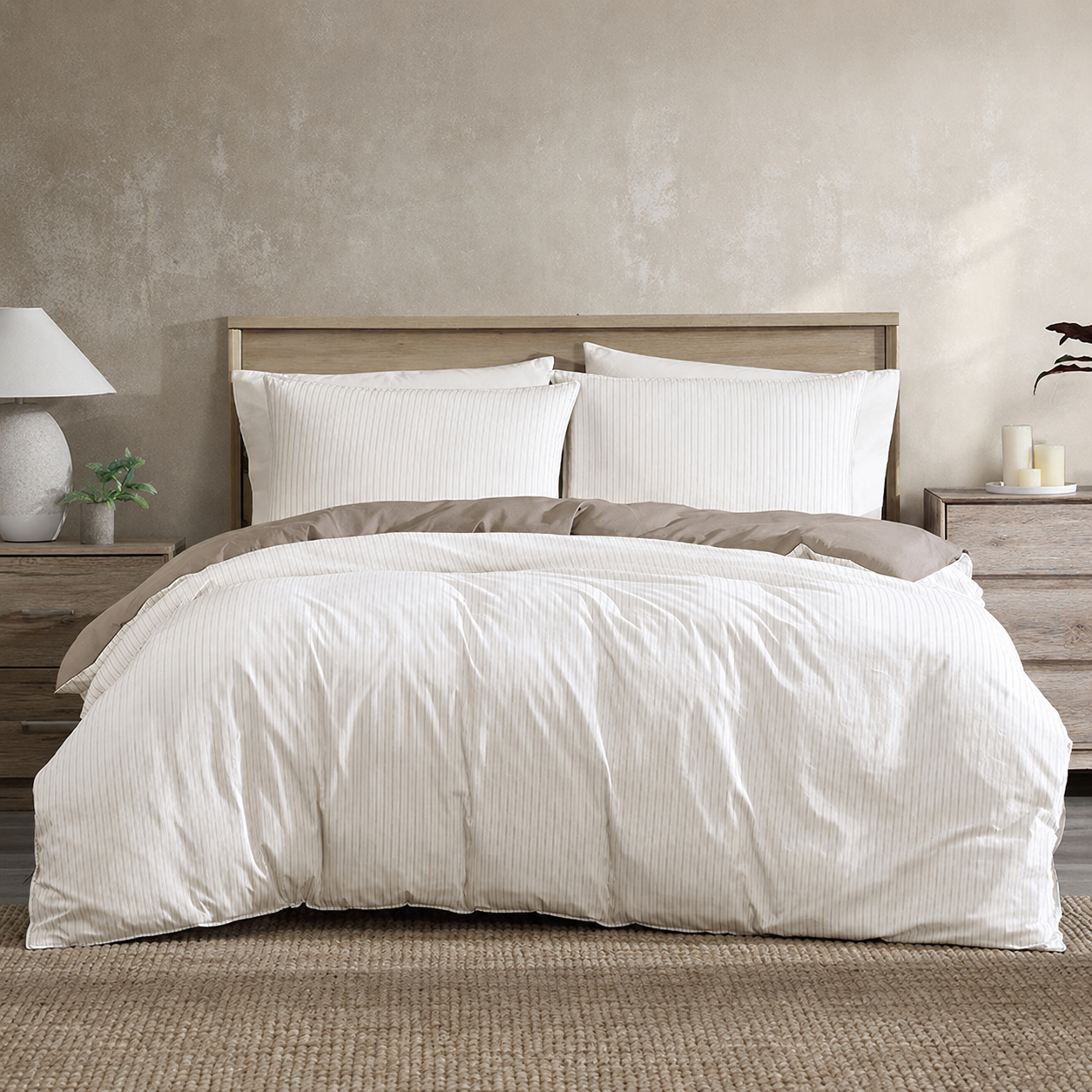 Neatly made bed with white bedding and brown accent pillows in a bedroom setting.