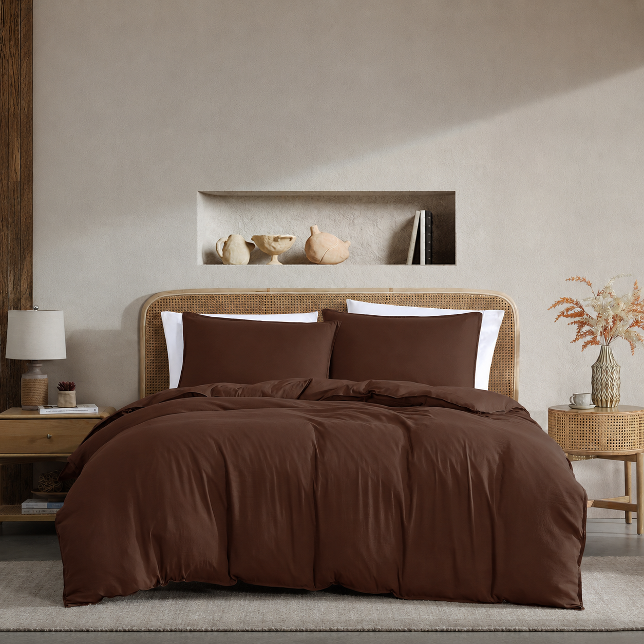 Bedroom with brown bedding and decorative items on a neutral wall.