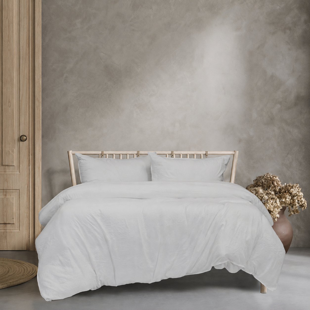Bed with white bedding against a textured wall