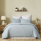 Fieldcrest Chunky Waffle Duvet Cover Set in Dusty Blue, styled on a bed with matching textured pillowcases in a warm neutral bedroom.