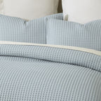 Close-up of the Dusty Blue Fieldcrest Chunky Waffle Duvet Cover Set, showing the raised waffle texture across the duvet cover and pillowcases.