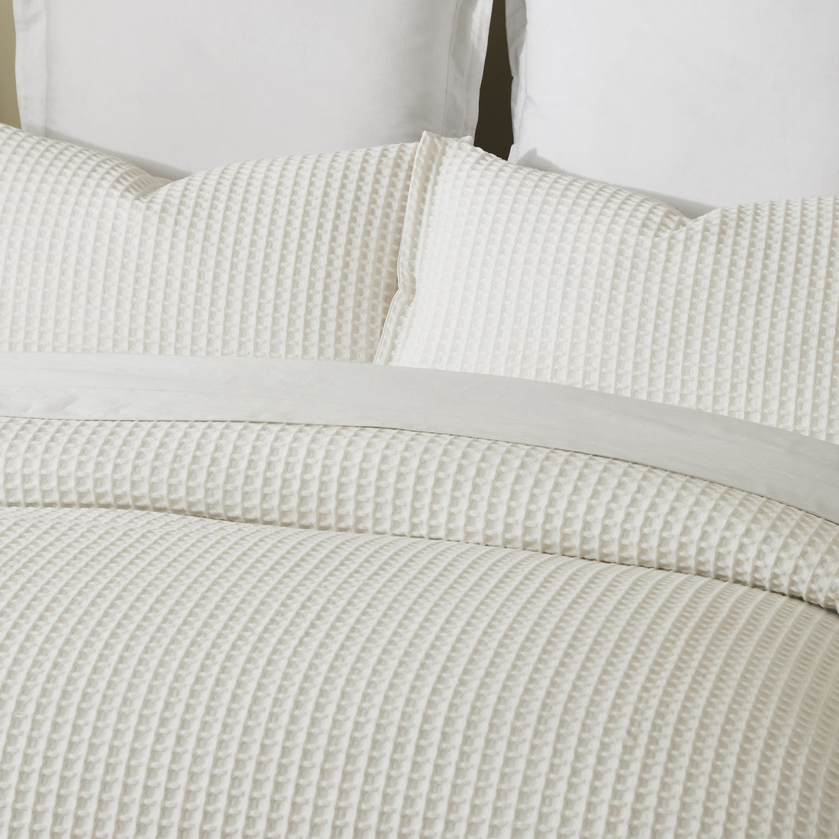 Close-up of the Off White Fieldcrest Chunky Waffle Duvet Cover Set, showing the raised waffle texture across the duvet cover and pillowcases.