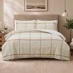 Fieldcrest Ward Cotton Check Duvet Cover Set in Cream styled on a bed with matching pillowcases, featuring a large check pattern with warm brown stripes.