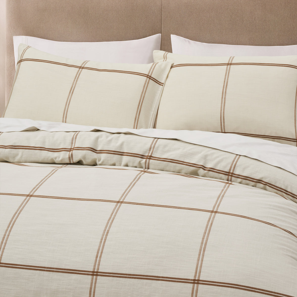 Detailed view of the Fieldcrest Ward Cotton Check Duvet Cover Set in Cream, featuring matching pillowcases and a classic brown check pattern on a soft cream background.