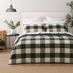 Green oversized check duvet cover set styled on a bed with two matching pillowcases, white pillows and greenery.
