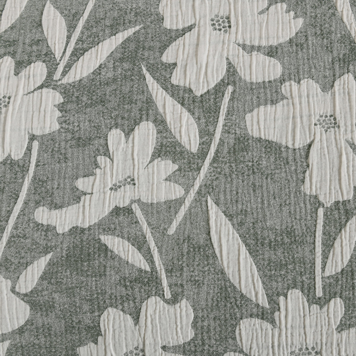 Close-up of the green and white floral pattern showing the textured cotton fabric and floral design.