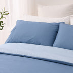 Close-up of the blue Solace Arden Reversible Duvet Cover Set, showing deep blue pillowcases and the lighter blue reverse folded over the duvet.
