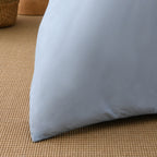 Close-up of the light blue reverse fabric of the Solace Arden Reversible Duvet Cover Set, showing the smooth plain finish.