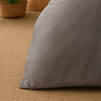 Close-up of the silver fabric of the Solace Arden Reversible Duvet Cover Set, showing its smooth plain finish and soft drape.