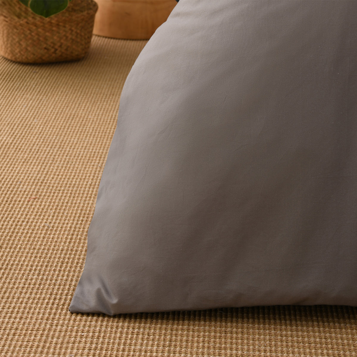 Close-up of the silver fabric of the Solace Arden Reversible Duvet Cover Set, showing its smooth plain finish and soft drape.