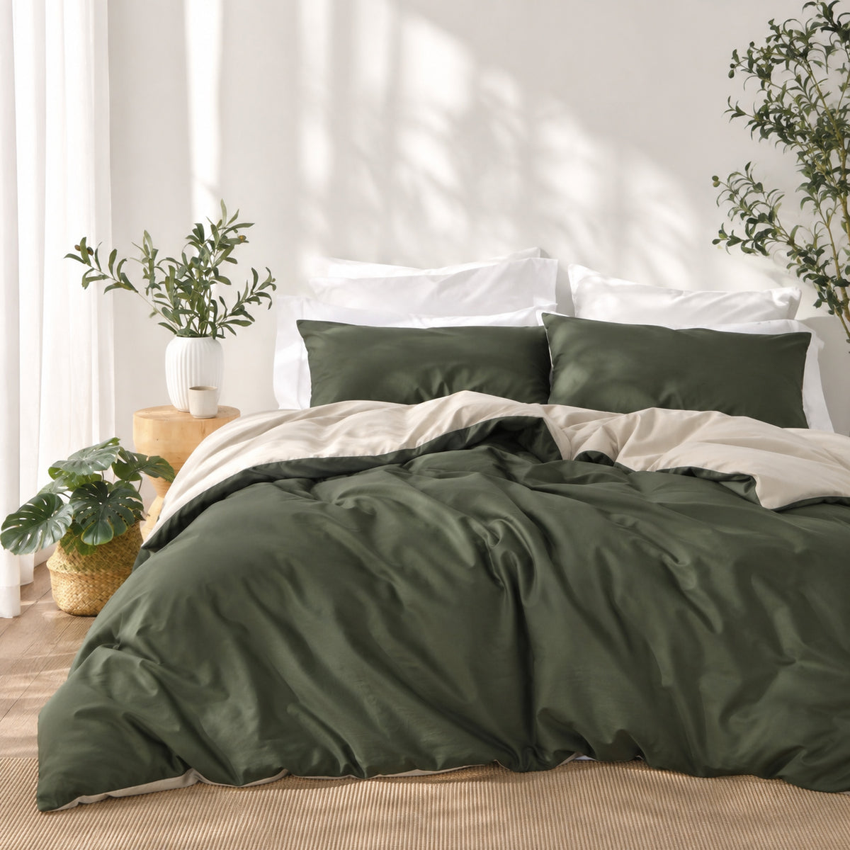 Solace Arden Reversible Duvet Cover Set styled in a green and natural colourway, featuring deep green bedding with a natural-toned reverse and coordinating pillowcases.