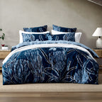 Logan & Mason Willa 100% Cotton Duvet Cover Set in Blue featuring a bold navy floral and botanical print with white and soft blue detailing, styled with coordinating pillowcases and white bedding.