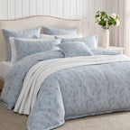 Private Collection Garden Veil Duvet Cover Set in Chambray styled with matching floral pillowcases, a white quilted throw and layered cushions in a classic bedroom.